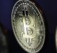 A collection of bitcoin tokens stand in this arranged photograph in London, U.K., on Wednesday, Jan. 4, 2017. The ...