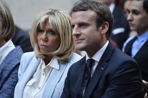 In this photo dated Tuesday, July 25, 2017, French First Lady Brigitte Macron and French President Emmanuel Macron attend a concert from the Pierre Claver association at the Elysee Palace in Paris, France.