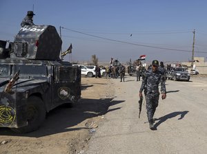 Iraqi Federal police deploy after regaining control of the town of Abu Saif, west of Mosul, Iraq, Wednesday, Feb. 22, 2017.