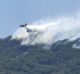 Fires in Italy: an anti-fire airplane flies over fires in the national park of mount Vesuvius near Naples, Italy.