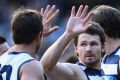 Patrick Dangerfield is congratulated by teammates after kicking a goal  against Hawthorn at the MCG on Saturday