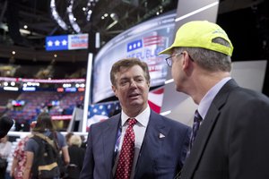 Trump Campaign Chairman Paul Manafort talks to delegates as he walks around the convention floor before the opening session of the Republican National Convention in Cleveland, Monday, July 18, 2016.