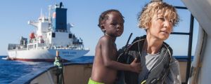 A Spanish nurse of Proactiva Open Arms NGO carries a child rescued from the Mediterranean Sea aboard the Golfo Azzurro ...