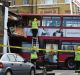 Emergency services personnel check a crashed double-decker bus in Lavender Hill.