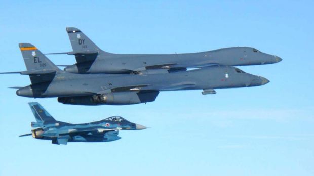 US Air Force B-1B bombers, top, fly with a Japan Air Self Defence Force F-2 fighter jet over Japan's southern island of ...