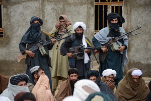 In this Nov. 3, 2015 file photo, Afghan Taliban fighters listen to Mullah Mohammed Rasool, the newly-elected leader of a breakaway faction of the Taliban, in Farah province, Afghanistan.