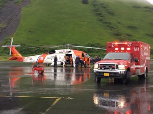 The U.S. Coast Guard and emergency medical personnel transfer patients from a MH-60 Jayhawk helicopter to an ambulance in Kodiak, Alaska, June 2, 2016