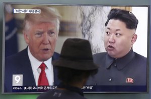 Donald Trump and Kim Jong Un during a news program at the Seoul Train Station in South Korea, Aug. 10, 2017