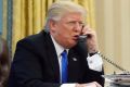 US President Donald Trump speaks on the phone with Prime Minister Malcolm Turnbull in the Oval Office of the White House ...