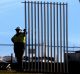 Workers installed the first section of a 2.6m high security fence across the front lawns of Parliament House in Canberra ...