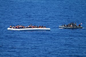 File - A visit, board, search and seizure team from the guided-missile destroyer USS Carney (DDG 64) approaches a migrant vessel in the Mediterranean Sea, 29 July, 2016.