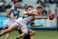 The Power's Ollie Wines gets the ball away at the MCG.