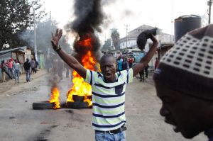 Supporters of Kenyan opposition leader and presidential candidate, Raila Odinga, demonstrate blocking roads with burning ...