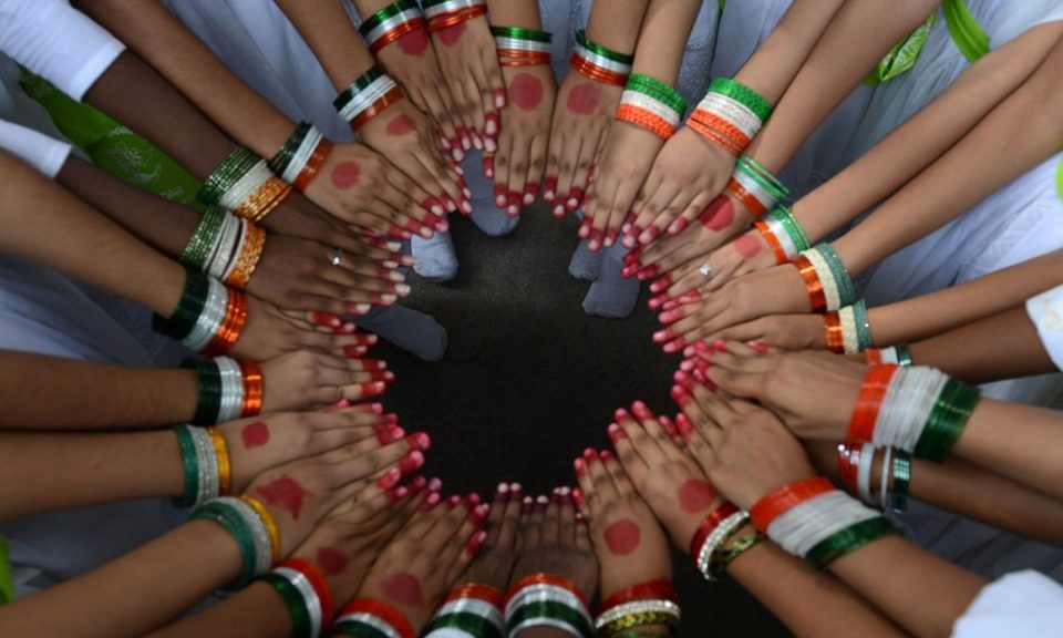 Schoolchildren wearing tricolor bangles pose in a circle during Indian Independence Day 
celebrations in Secunderabad. Photo/AFP/Files