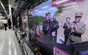 A TV news show an image of North Korean leader Kim Jong Un on a screen while reporting North Korea's missile test which landed in the waters of Japan's economic zone at a consumer-electronics retailer in Tokyo Tuesday, July 4, 2017.