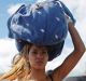 A woman carrying a bundle on her head waits in line to cross the border into Colombia through the Simon Bolivar ...