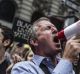 A demonstrator shouts into a megaphone during a rally outside of Trump Tower in New York.