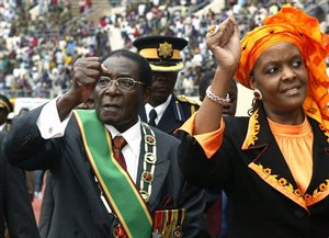  President Robert Mugabe, left and his wife Grace, greet supporters on their arrival for Independence Day celebrations in Harare, Tuesday, April 18, 2006. Mugabe used the 26th anniversary commemorations to hit back at claims up to 10,000 Zimbabweans have 