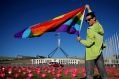 Marriage equality advocate Russell Nankervis poses for photographers with the rainbow flag during a 'Sea of Hearts' ...