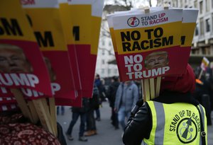 Campaigners demonstrate outside the United States Embassy, as they protest about the inauguration of U.S President Donal Trump, in  London, Friday, Jan. 20, 2017.