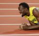 Jamaica's Usain Bolt lies on the track after injuring himself during the men's 4x100m final at the World Athletics ...