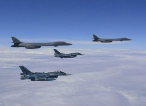 In this Tuesday, Aug. 8, 2017 image released by the Joint Staff Office of the Defense Ministry of Japan, Japanese fighter jets, foreground, and U.S. Air Force B-1B Lancer bombers, background, fly over Japan's southern island of Kyushu during their joint exercise.