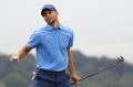 Golden State Warriors NBA basketball player Stephen Curry reacts after making a putt to save par on the 18th green ...
