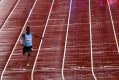 One is the loneliest number: Botswana's Isaac Makwala crosses the finish line in his heat.