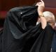 One Nation Senator Pauline Hanson takes off a burqa during Senate Question Time at Parliament House in Canberra, ...
