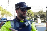 Police officers tell members of the public to leave the scene in a street in Barcelona.