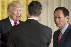 In this July 26, 2017, photo, President Donald Trump arrives and greets House Speaker Paul Ryan of Wis., and Terry Gou,