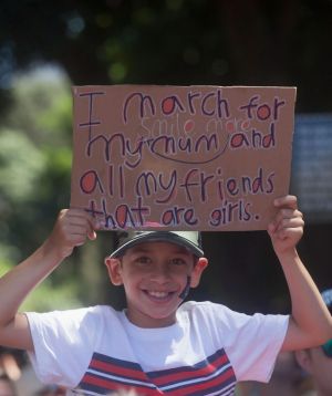 A young boy holds a sign at the Sydney march.