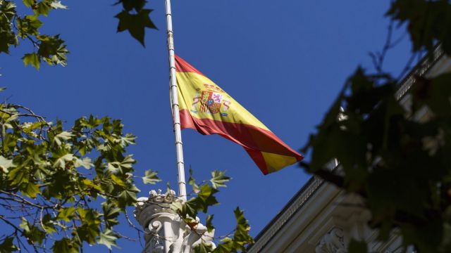 The Spanish flag flies at half staff above the Madrid stock exchange.