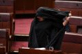 Pauline Hanson removes her burqa after the Senate stunt.