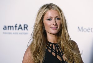 Paris Hilton poses on the red carpet for the fundraising gala organized by amfAR (The Foundation for AIDS Research) in Hong Kong Saturday, March 14, 2015.