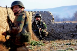 A soldier in the Afghan National Army takes cover behind a wall while receiving enemy fire during Operation New Hope, Kajaki, Afghanistan, Jan. 16. During the operation, the ANA partnered with the Afghan National Civil Order Police and the Afghan Uniform Police in an effort to bring peace, stability and increase the Government of the Islamic Republic of Afghanistan’s influence in the area. Afghan National Security Forces localized their efforts to Kajaki Sofala, part of the southern green zone in Kajaki, and a known insurgent hotbed in the district.