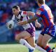 Storm's Billy Slater goes for a run against the Newcastle Knights.