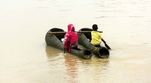 Local people using boats to Carry Drinking Water to  commute in flood-hit Ghatal locality in West Midnapore district of West Bengal on Monday 31 July 2017