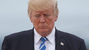 President Donald Trump walks across the tarmac before boarding Air Force One at Hagerstown Regional Airport, Aug. 18, ...