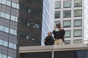 Members of the Secret Service stand guard on a roof of a building on Fifth Avenue before President Donald Trump's motorcade leaves Trump Tower, Wednesday, Aug. 16, 2017, in New York.