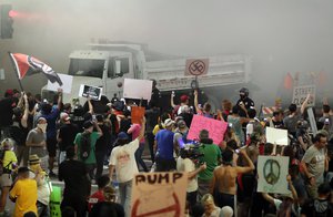 Protesters yell after Phoenix police used tear gas outside the Phoenix Convention Center, Tuesday, Aug. 22, 2017, in Phoenix.