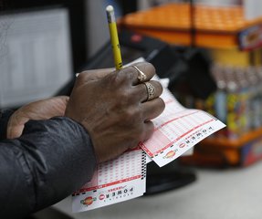 A lottery player waits in line to purchase tickets for The Power Ball drawing at a Pilot convenience store Wednesday, Jan. 13, 2016, in Tallpoosa, Ga.