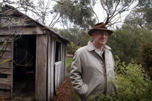 Allan Myers, QC, on his property in Dunkeld beside a hut where his great-grandfather lived.