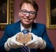 Daniel Mansfield holds the 3700-year-old Babylonian tablet that he and colleagues used to make their case.