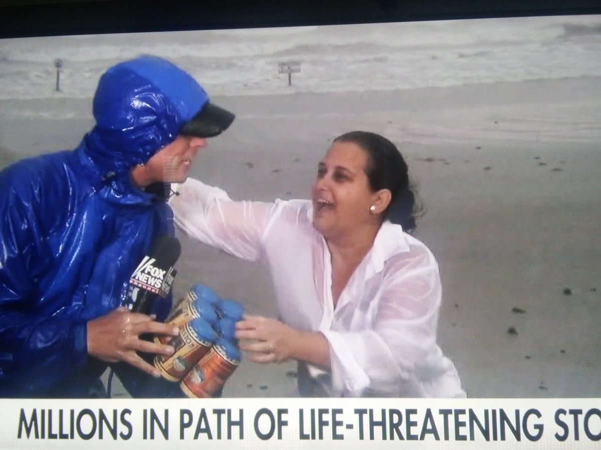 Woman offers weather reporter a beer in rain-soaked Texas