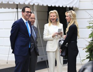 Treasury Secretary Steven Mnuchin, left, and his wife Scottish actress Louise Linton, right, and Secretary of Commerce Wilbur Ross, second from left, and his wife Hilary Geary, second from right, wait for President Donald Trump on the South Portico of the White House Washington, Saturday, July 29, 2017.   (AP Photo/Manuel Balce Ceneta)