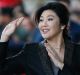 Former Thai prime minister Yingluck Shinawatra waves to supporters as she arrives at the Supreme Court for her final ...