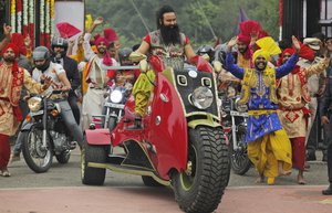 In this Wednesday, Oct. 5, 2016 photo, Indian spiritual guru, who calls himself Saint Dr. Gurmeet Ram Rahim Singh Ji Insan, arrives for a press conference ahead of the release of his new film “MSG, The Warrior Lion Heart,” in New Delhi, India.