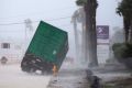 A power generator tips as strong winds hit the region.