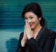 Yingluck Shinawatra thanks supporters as she arrives at the Supreme Court for her final statements on August 1. She ...